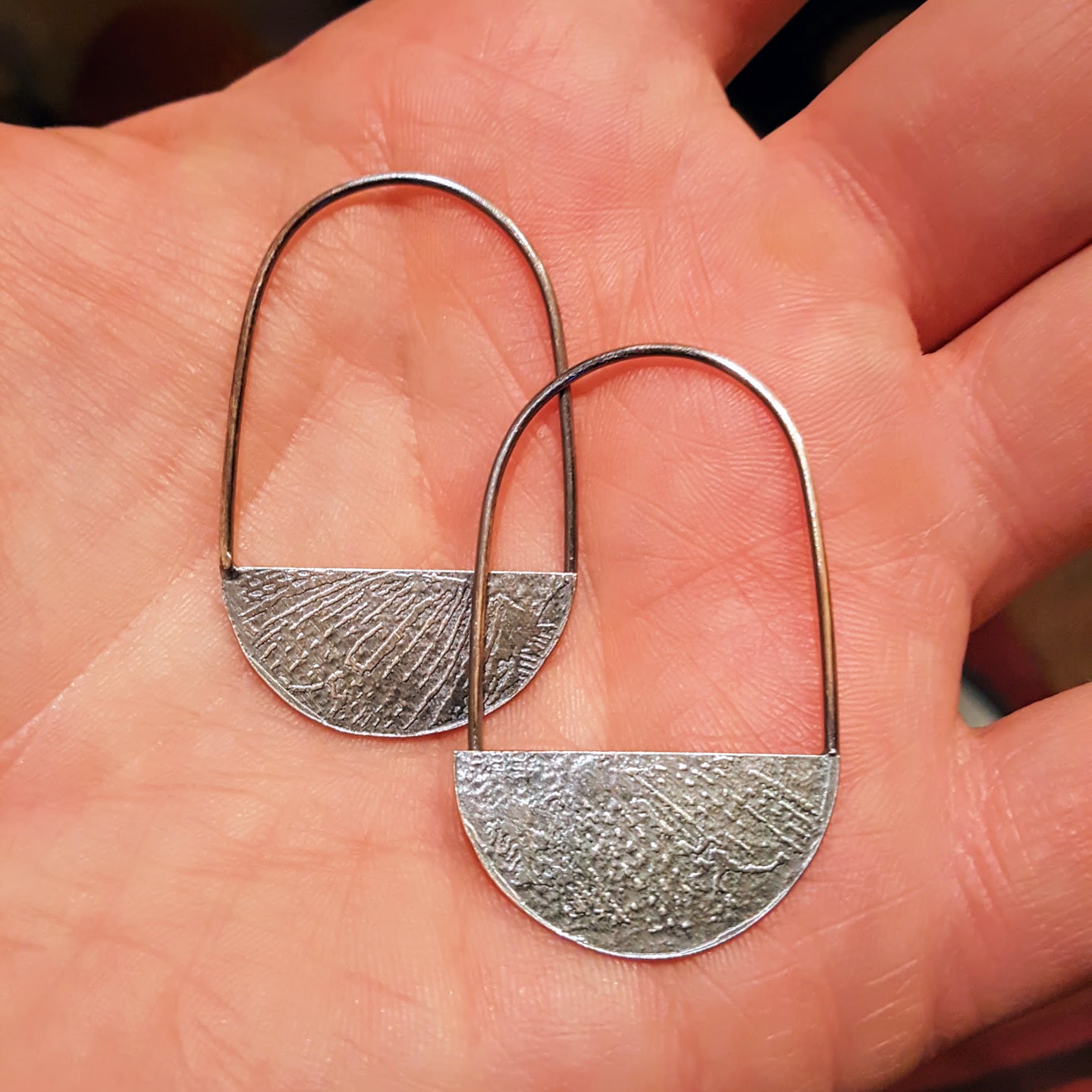 A view of the etched side of the earrings
