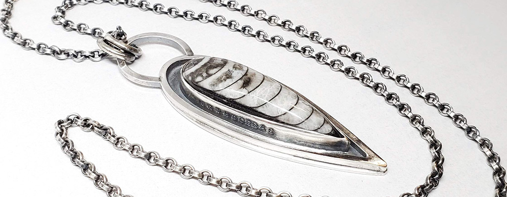 A sterling silver necklace set with an othoceras fossil