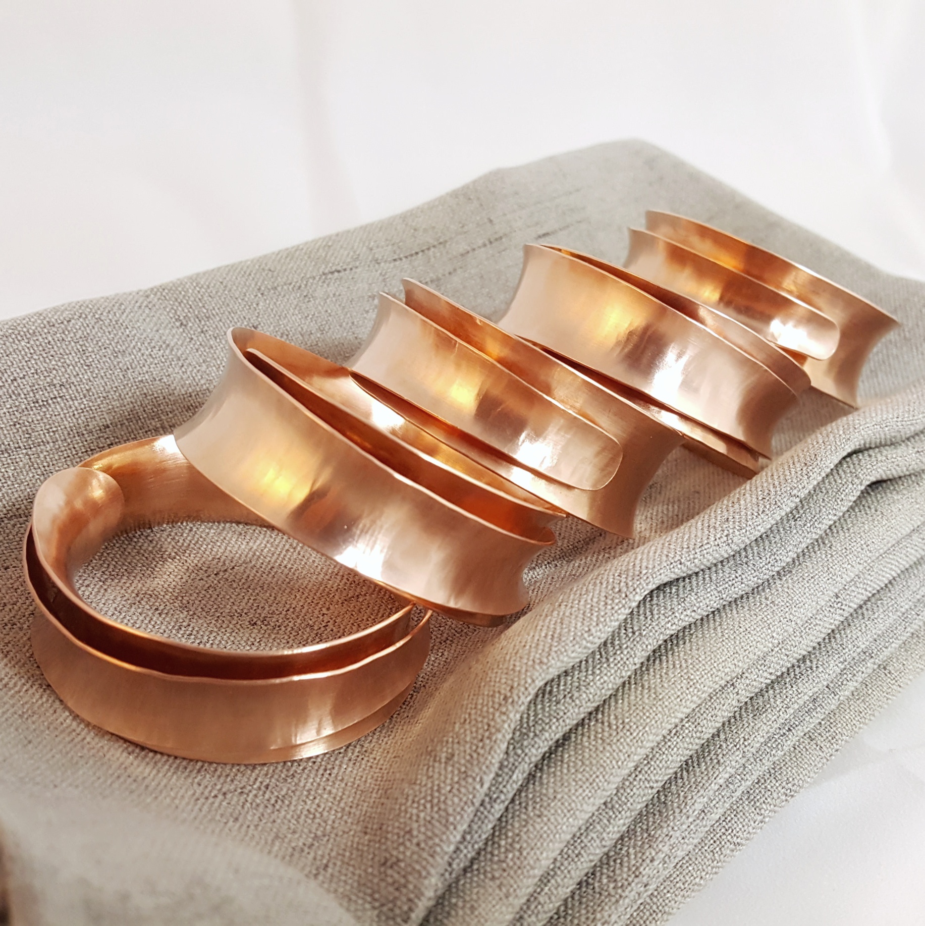 Copper napkin rings, stacked on eachother