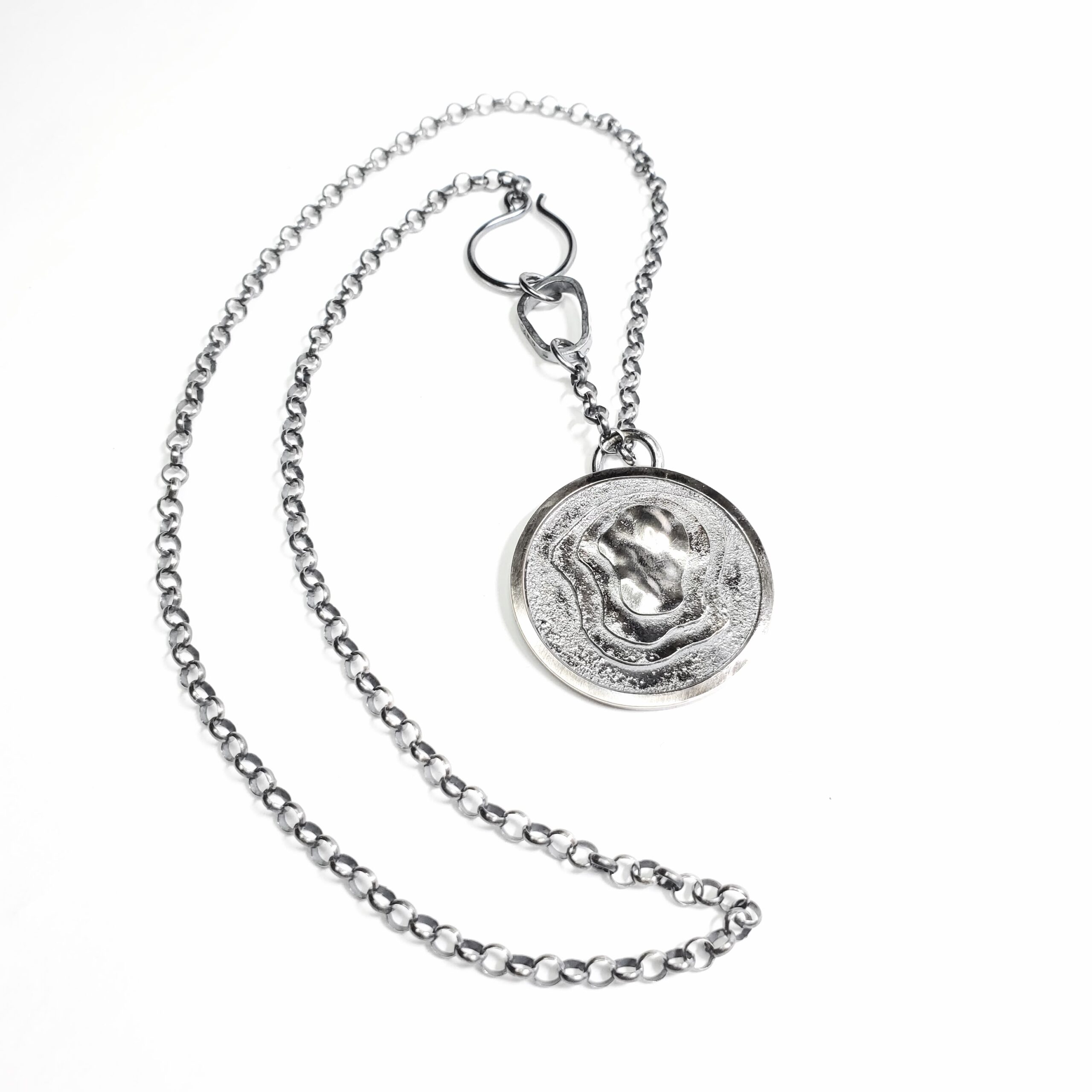 A round pendant and necklace from the terrane series