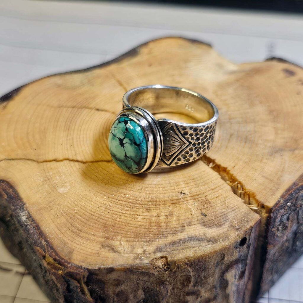 A stamped turquoise ring