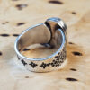 A stamped Hubei turquoise ring on a wood surface