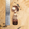 A small condiment spoon on a wood surface.