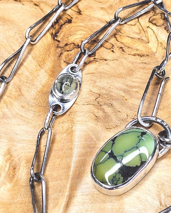 GreenTurquoiseNecklaceClose-opt A green turquoise pendant on a handmade silver chain. A Prehenite cabochon is set in the chain to accent the green of the turquoise