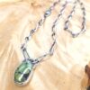GreenTurquoiseNecklaceDiagonal-opt A green turquoise pendant on a handmade silver chain. A Prehenite cabochon is set in the chain to accent the green of the turquoise
