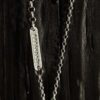 A necklace featuring a map marker planchette pendant made with reticulated silver and framed in a narrow sterling silver strip