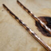RusticChopsticks-Tops-opt A close up of the top end of the Twisted Copper Chopsticks on a wood background