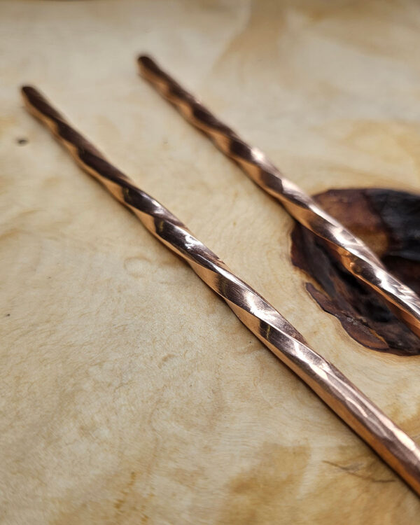 RusticChopsticks-Tops-opt A close up of the top end of the Twisted Copper Chopsticks on a wood background