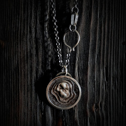 The pendant hanging on a black wood background