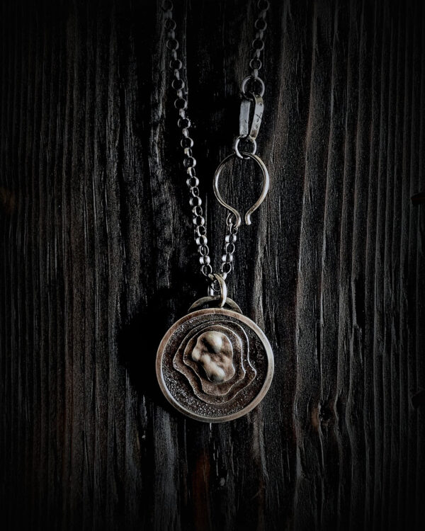 The pendant hanging on a black wood background