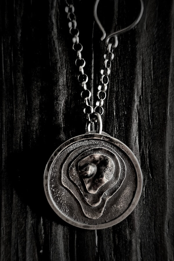 The pendant hanging on a black wood background