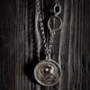 The pendant hanging on a black wood background