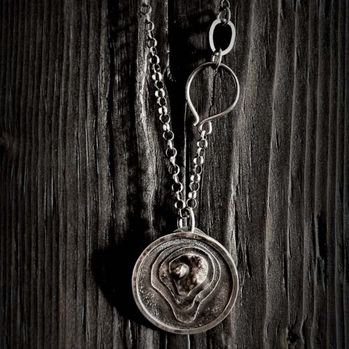 The pendant hanging on a black wood background