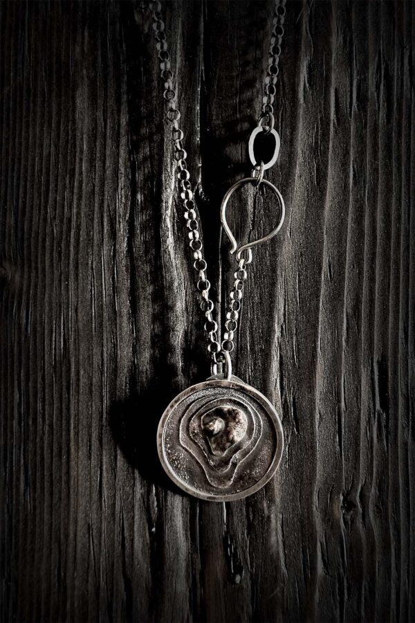 The pendant hanging on a black wood background