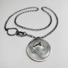 The pendant hanging on a black wood background