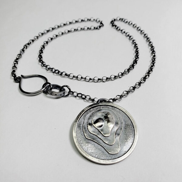 The pendant hanging on a black wood background